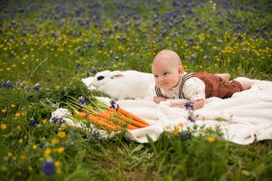 Photo of baby with bunny in flowers